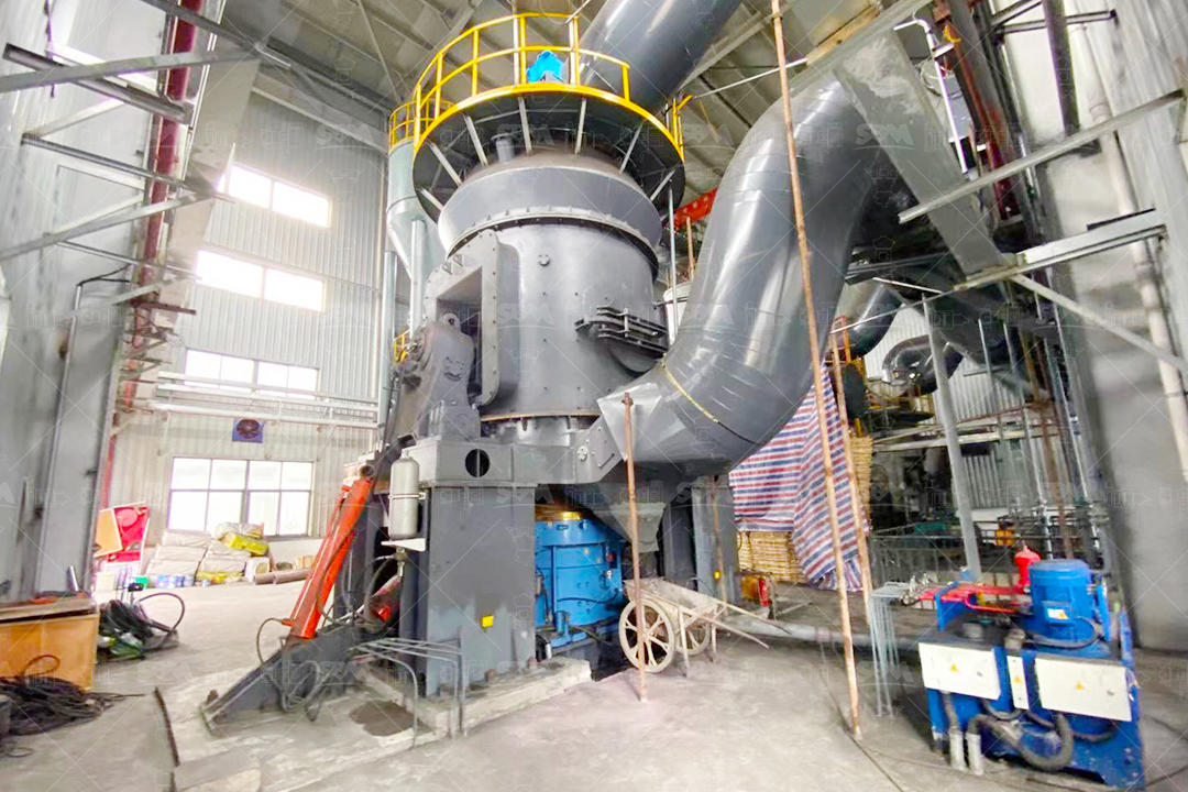 Cross-sectional diagram of a vertical roller mill showing grinding table, rollers, classifier, and drive system.