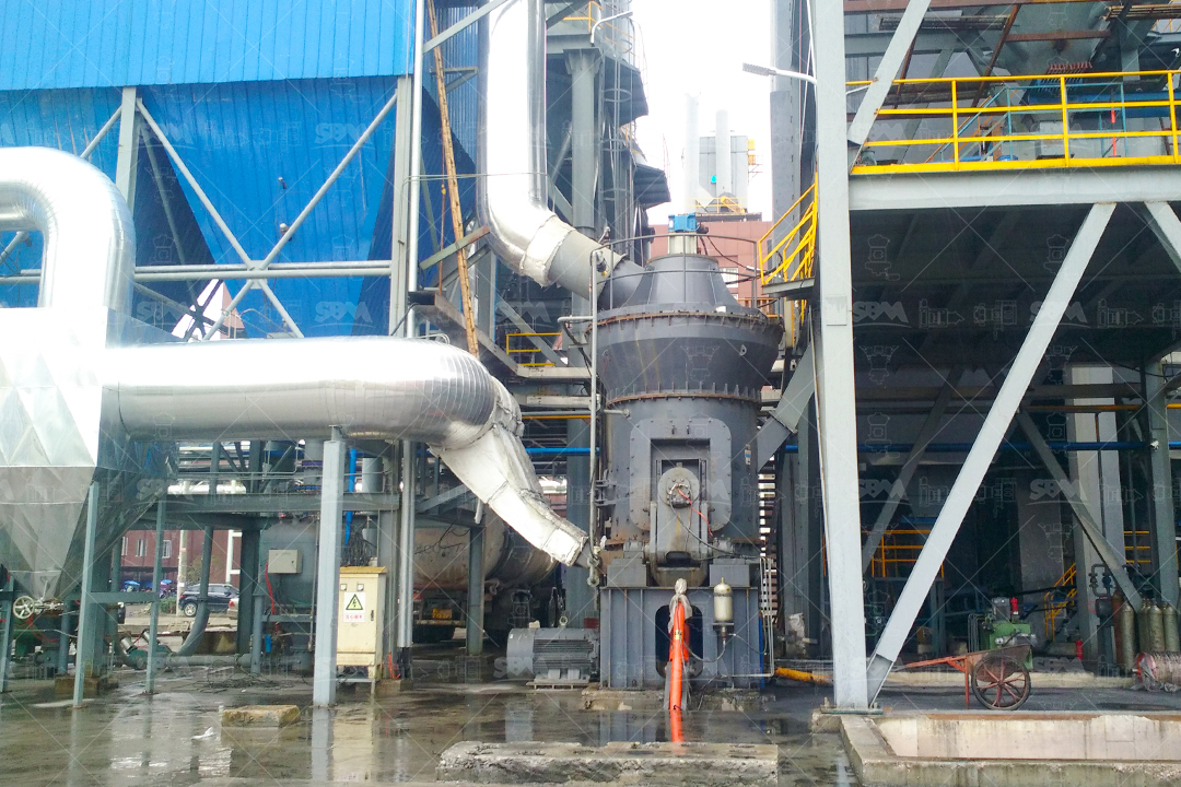 Operator monitoring SBM LUM Vertical Mill's PLC control panel displaying real-time energy consumption and grinding parameters